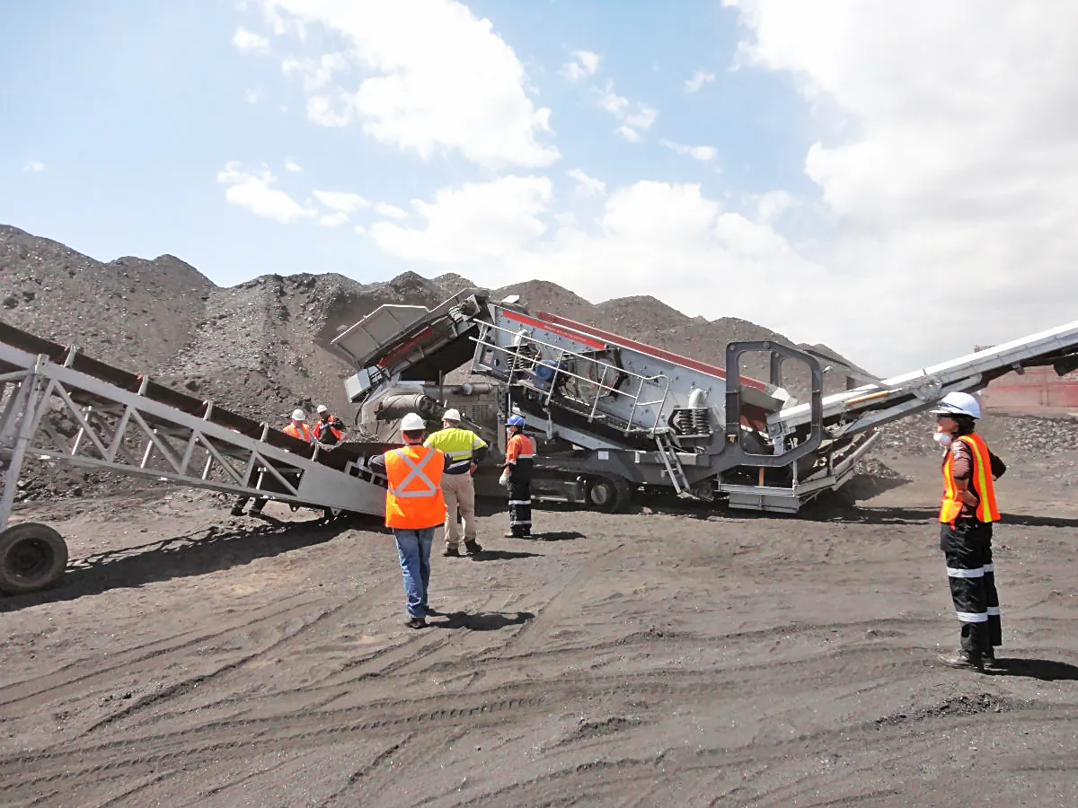 Panoramic view of a tire type mobile crushing plant working in a quarry