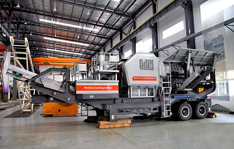 Work site layout with a tire mounted mobile crusher and loader feeding it